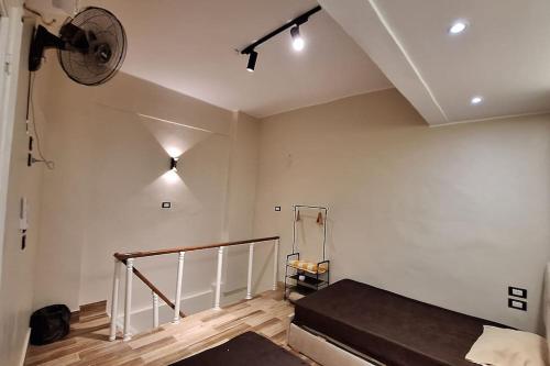 a room with a bed and a ceiling fan at Grand Duplex in Aswan
