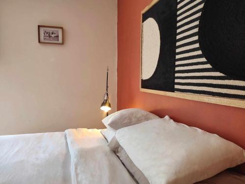 a bedroom with a bed and a painting on the wall at Queen Bedroom in Aljezur