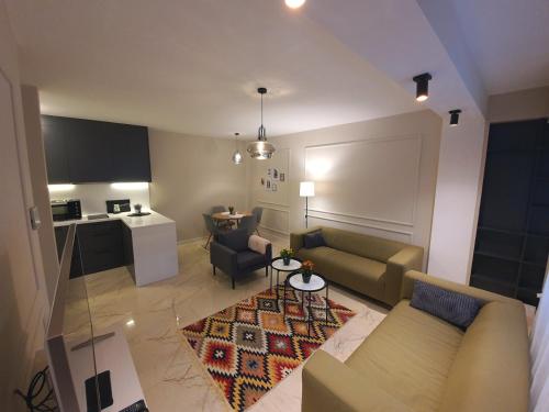 a living room with a couch and a table at Studio Apartments in Novi Pazar