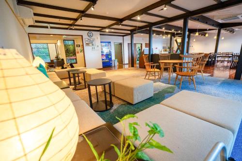 a room with tables and chairs and tables and chairs at Marine Blue Yakushima in Yakushima