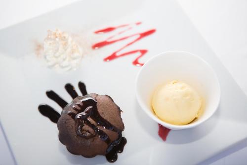 a chocolate dessert next to a bowl of ice cream at Hotel Son Trobat Wellness & Spa in Sant Llorenç des Cardassar