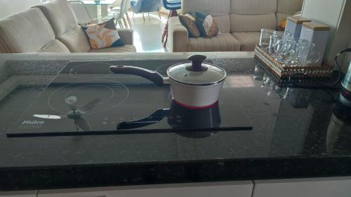 a slow cooker on a counter in a living room at Apartamento em Tramandaí in Tramandaí