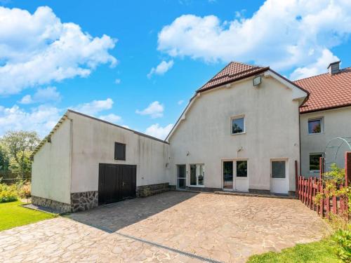 a large white building with a garage at Spacious Villa with Tennis in Elsenborn