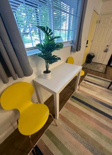 a room with a table and yellow chairs and a potted plant at Nationwide Childrens Hospital close by in Columbus