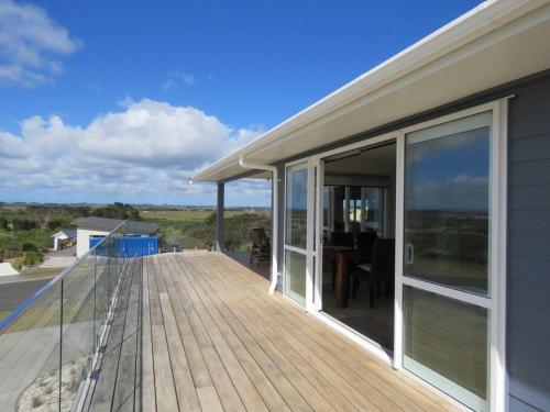 a large deck with a view of the ocean at Karikari Vista in Karikari Peninsula
