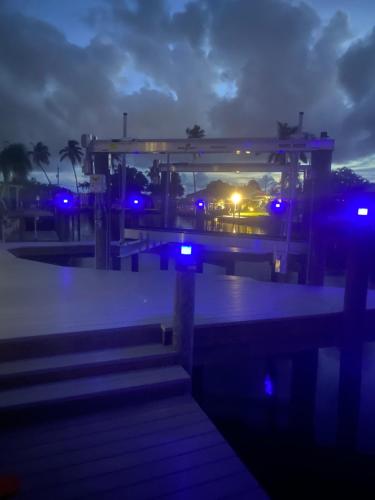 a night view of a building with blue lights at Hot tub and Dock Gilligan's on the Island in Matlacha