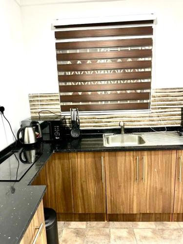 a kitchen with a sink and a window at Kan's Krib in Accra