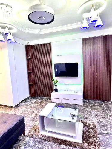 a living room with a tv and a couch at Kan's Krib in Accra