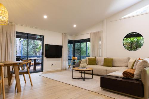 a living room with a couch and a table at Surfside Retreat in Gnarabup