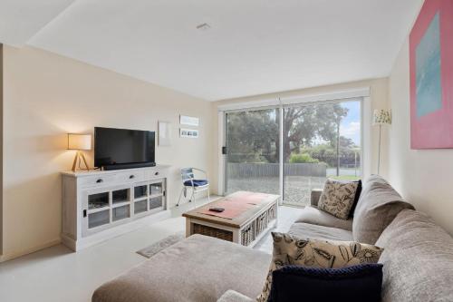 a living room with a couch and a tv at Range View House 23 Bristow Smith Ave Goolwa South-No Linen Included in Goolwa South