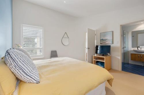 a bedroom with a large bed and a sink at Range View House 23 Bristow Smith Ave Goolwa South-No Linen Included in Goolwa South