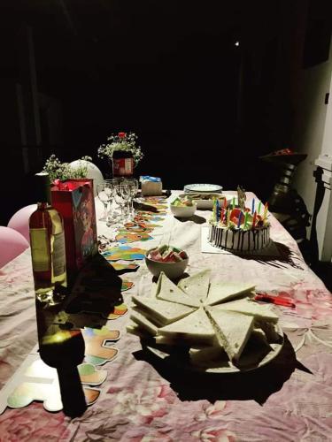 a table with a table cloth with food on it at Sara's Grove Boutique Bungalow in Haputale
