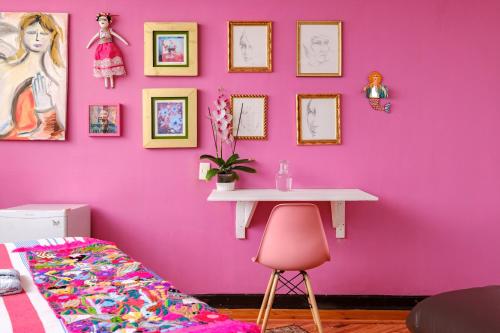 a pink room with a table and a pink wall at Casa Itzae B&B Polanquito Dog Friendly in Mexico City