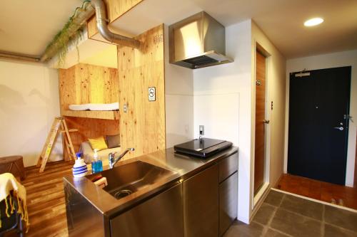 a kitchen with a sink and a counter top at 365BASE outdoor hostel in Hamamatsu