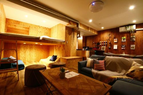 a living room with a couch and a table at 365BASE outdoor hostel in Hamamatsu