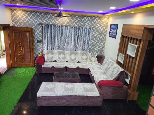 a living room with a couch and a table at The Grassland homestay in Chikmagalūr