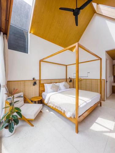 a bedroom with a canopy bed in a room at Tannari Villa Ubud in Ubud
