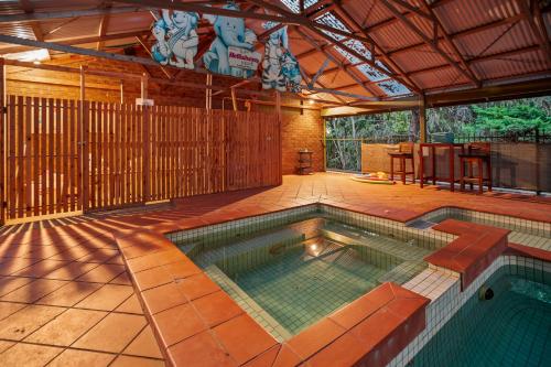 an indoor swimming pool in a house with a patio at StayAU The Homestead 4BR Spacious Nature Retreat in Badger Creek