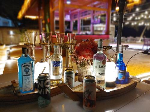 a group of bottles of alcohol sitting on a table at Easy Backpackers Paradise in Sihanoukville
