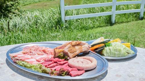 a plate of food with meat and vegetables on a table at El Patio Ranch in Aso
