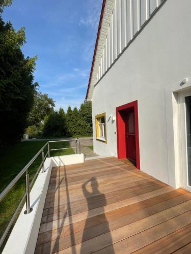 a shadow of a person walking on a wooden deck at Große helle Wohnung in Halle Westfalen