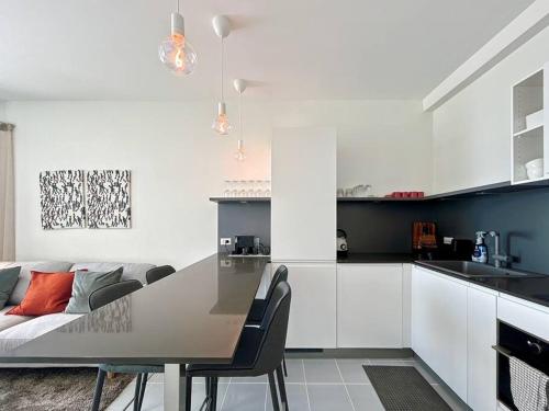a kitchen and living room with a table and a couch at Seaview 2 bed in the heart of Hua Hin - BP2 in Hua Hin