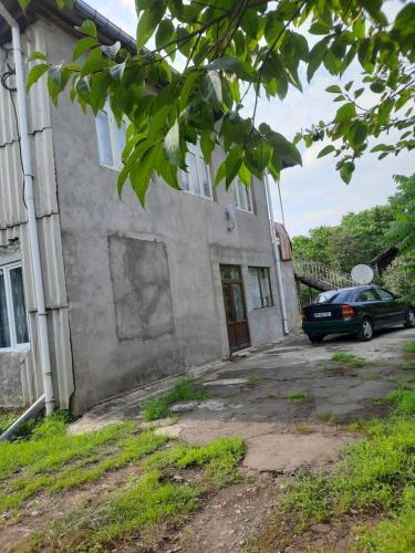 a car parked in front of a building at Guruli sakhli Nena in Ozurgetʼi