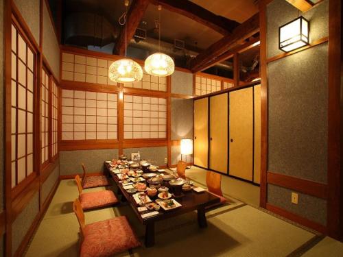 a dining room with a long table with food on it at Hotel Shirakawa Yunokura in Nikko