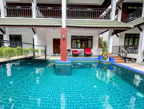 a swimming pool in the middle of a building at Amara Beach Resort Koh Phangan in Haad Yao