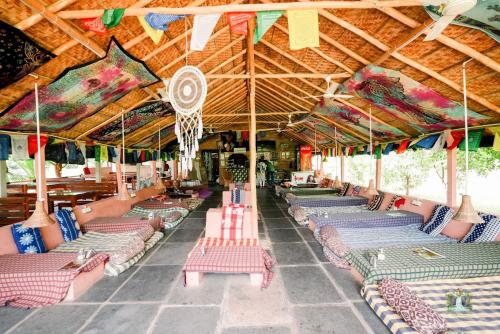 a group of beach loungers in a pavilion at Hampi Waterfall Cottages in Hampi
