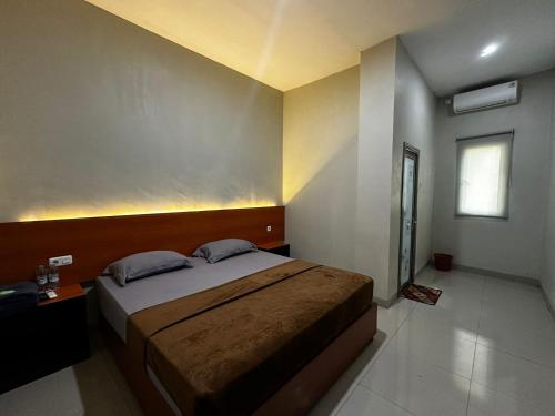 Postel nebo postele na pokoji v ubytování Grands Orchid Hotel