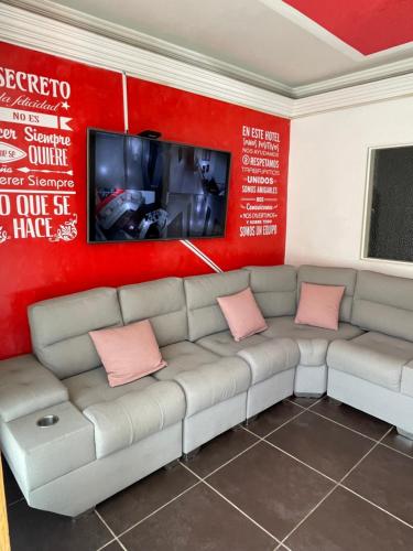 a living room with a couch and a flat screen tv at Hotel Las Vegas in Guatapé