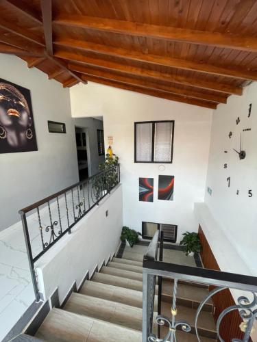 a staircase in a house with clocks on the walls at Hotel Las Vegas in Guatapé