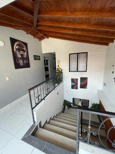 a staircase in a house with wooden ceilings at Hotel Las Vegas in Guatapé