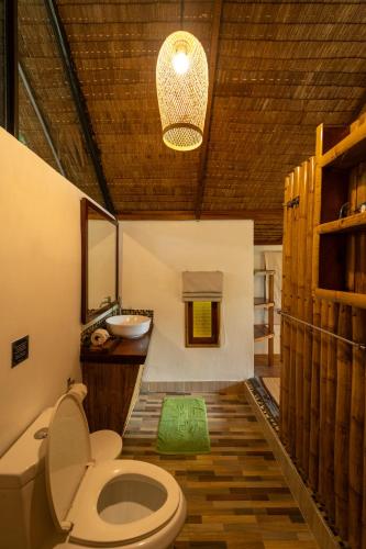 a bathroom with a toilet and a sink at Bamboo Bay Eco Resort in Srithanu
