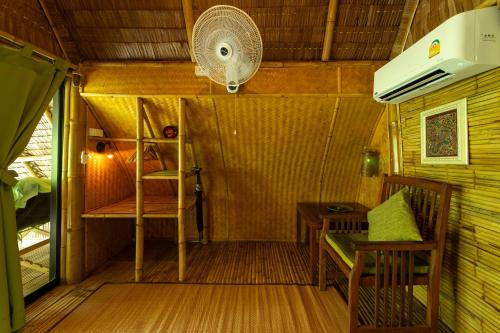 a small room with a table and a fan at Bamboo Bay Eco Resort in Srithanu
