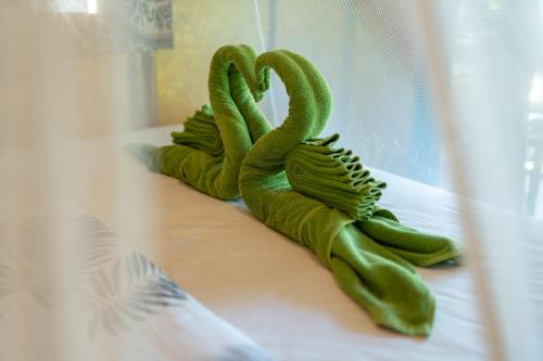 a group of green stuffed animals sitting on a window sill at Bamboo Bay Eco Resort in Srithanu