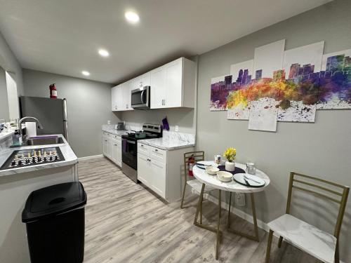 a kitchen with a sink and a table in it at Games Haven with Crib Mins from AT&T, Sixflags, UTA, GlobeLife, AmericanAirlinesCenter in Arlington
