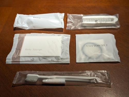 a group of toothpaste and a toothbrush in plastic bags at Log cabin rentals & Finland sauna Step House in Yamanakako