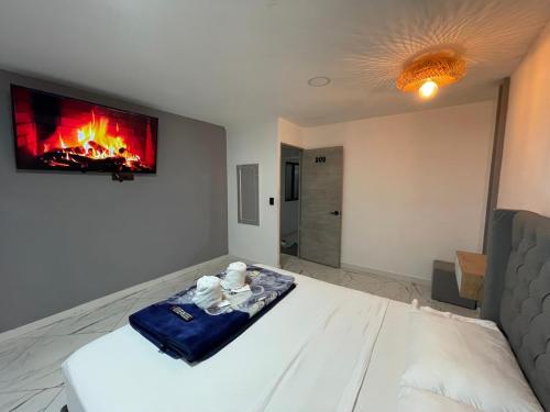 a bedroom with a bed with a fireplace on the wall at Hotel Las Vegas in Guatapé