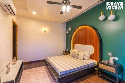 a bedroom with a bed and a green wall at StayVista at Wandering Vines 4BHK with FREE Breakfast ,Indoor Pool in Delhi Sohna in Sohna