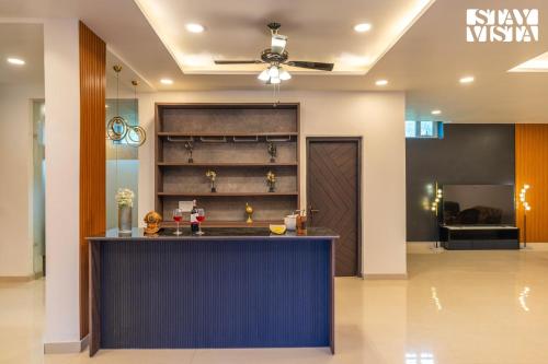 a lobby with a blue counter in a building at StayVista at Wandering Vines 4BHK with FREE Breakfast ,Indoor Pool in Delhi Sohna in Sohna