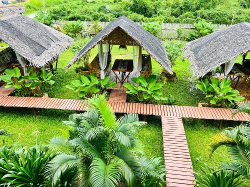 an aerial view of a house with a wooden walkway at La Palapa Inn Port Barton in San Vicente