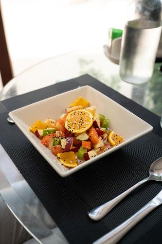 a white plate of food on a glass table at Thundi Village & Spa in Maalhos