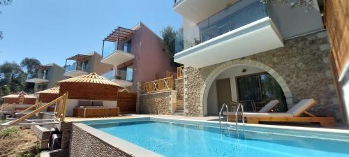 a house with a swimming pool next to a building at Filoxenia Sea View in Parga