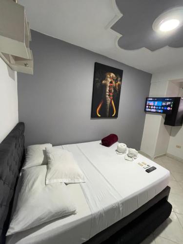 a bedroom with a bed with a picture of a skeleton at Hotel Las Vegas in Guatapé