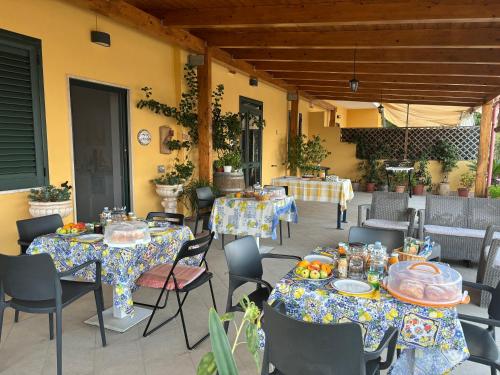 a patio with tables and chairs with food on them at B&B CASA MARTINA in Giungano