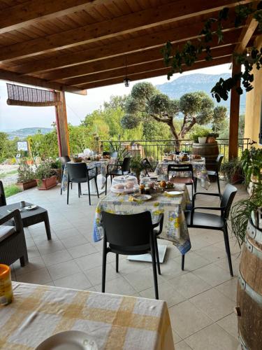 a patio with tables and chairs with a view at B&B CASA MARTINA in Giungano
