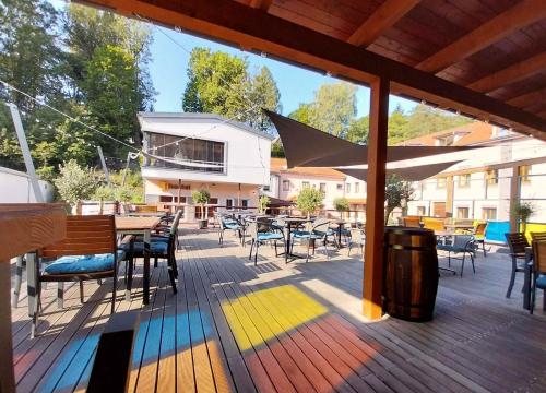 a deck with tables and chairs and a colorful floor at Hotel Fabrica in Liberec