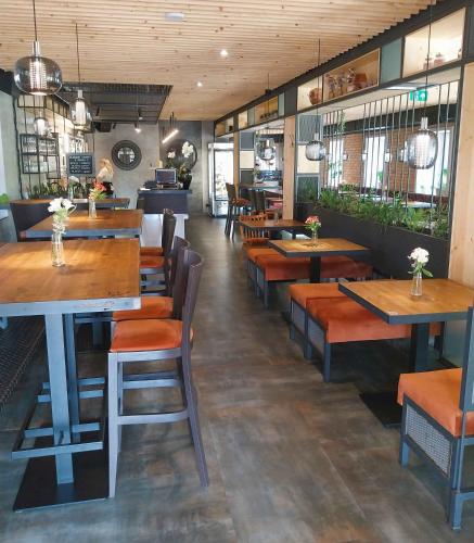 a restaurant with wooden tables and benches in a room at Hotel Fabrica in Liberec